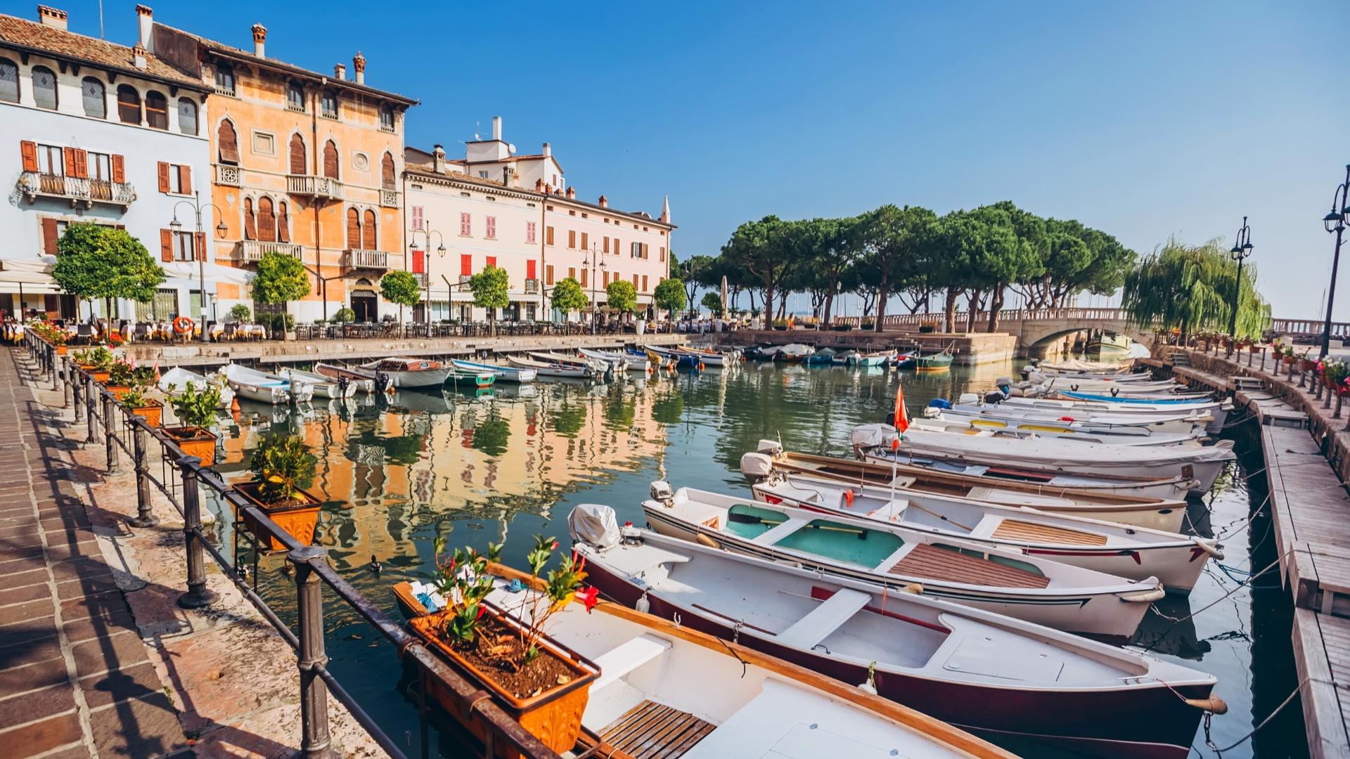 Picturesque harbor with moored boats and colorful buildings.