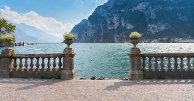 Beautiful lake view with mountains and blue sky in the background.