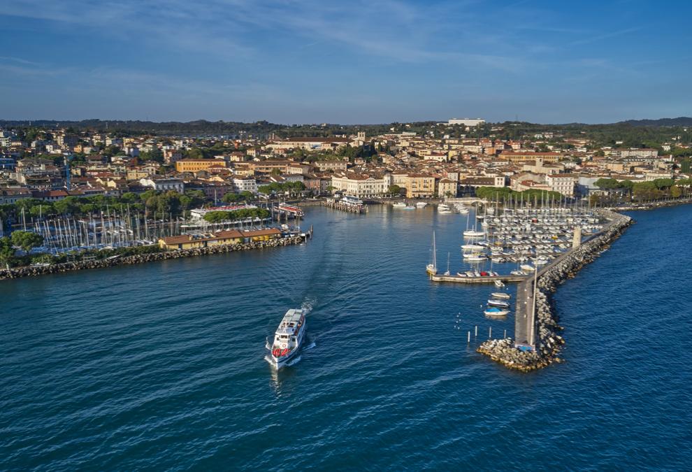 Panoramic view of a coastal city with historic buildings and a harbor.