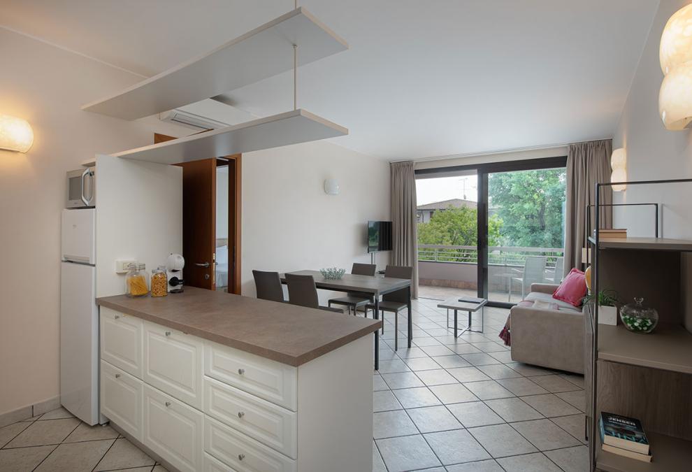 Modern apartment with kitchen, living room, and balcony.